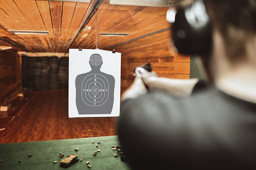 focused male trying to score high on gun practicing range